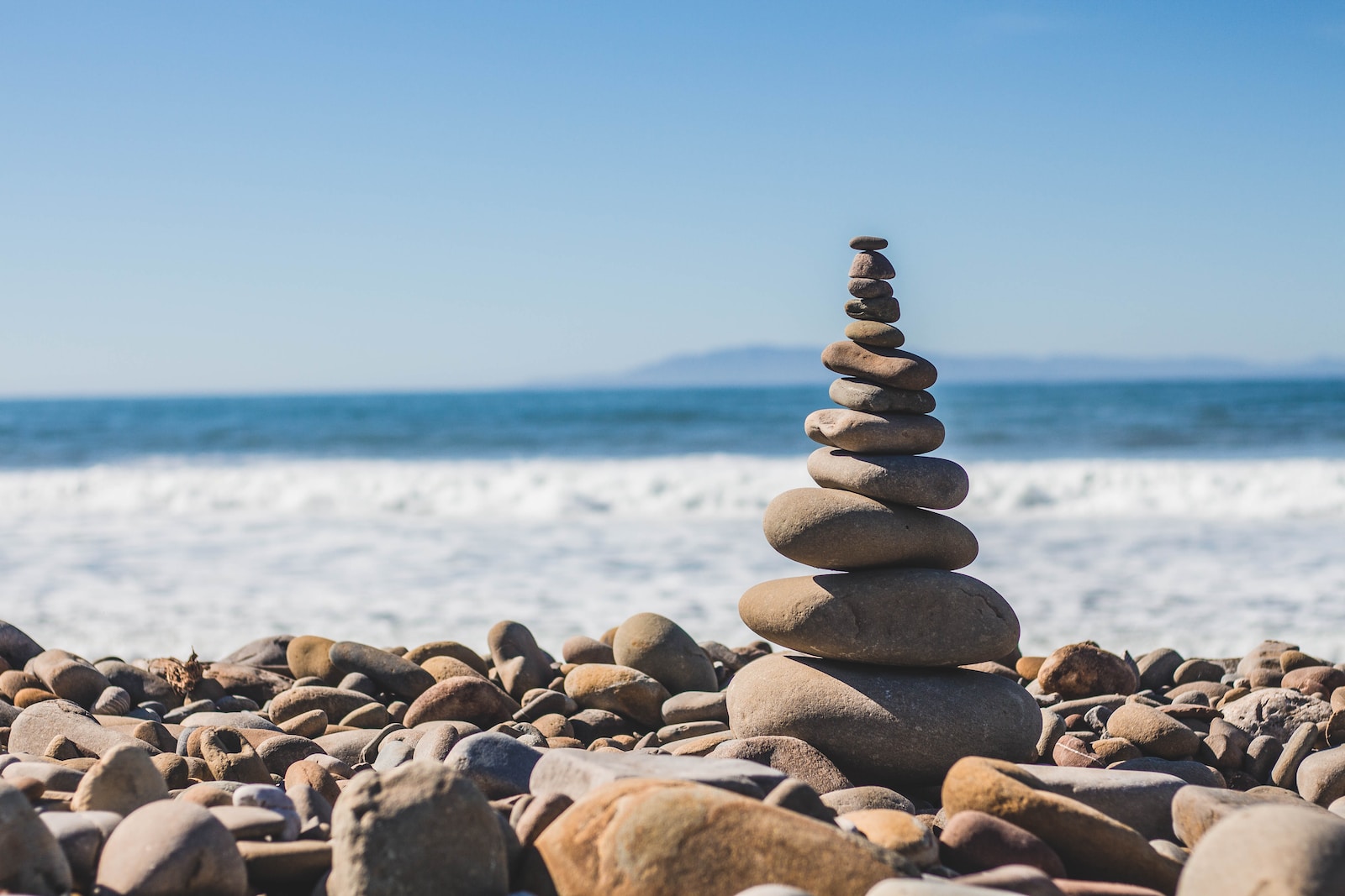 stack rock on seashore, depicting balance